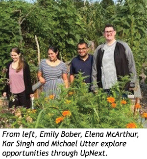 Four people, Emily Bober, Elena McArthur, Kar Singh, and Michael Utter, stand in a garden.