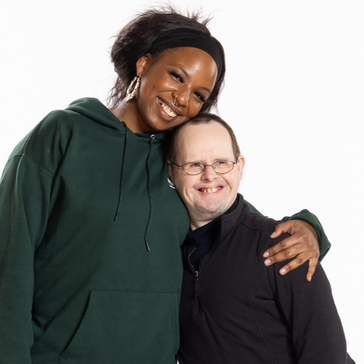 A smiling woman with her arm around a smiling man in the Fall 2026 Spirit Newsletter.